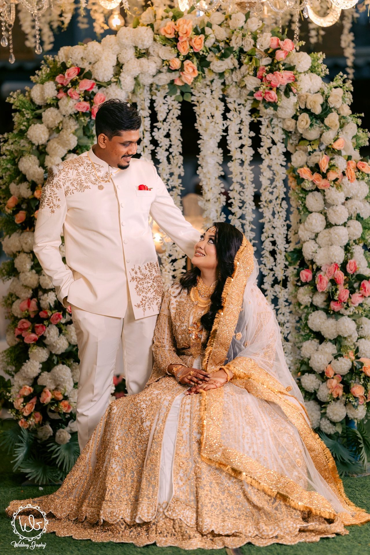 ফুলেল আর্চের সামনে দম্পতি - A couple in front of a floral arch
